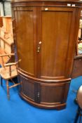 A late 19th or early 20th Century double height bow fronted corner cupboard, height approx. 168cm