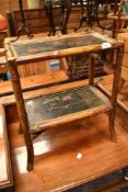 An Antique two tier plant stand in the oriental style having simulated bamboo frame
