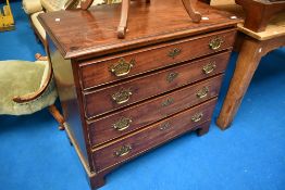 A 19th Century mahogany chest of four long drawers having Georgian brass handles and bracket feet,