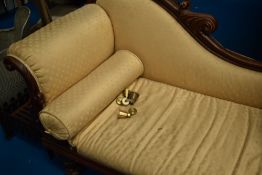 A Victorian chaise longue having scroll frame and later upholstery