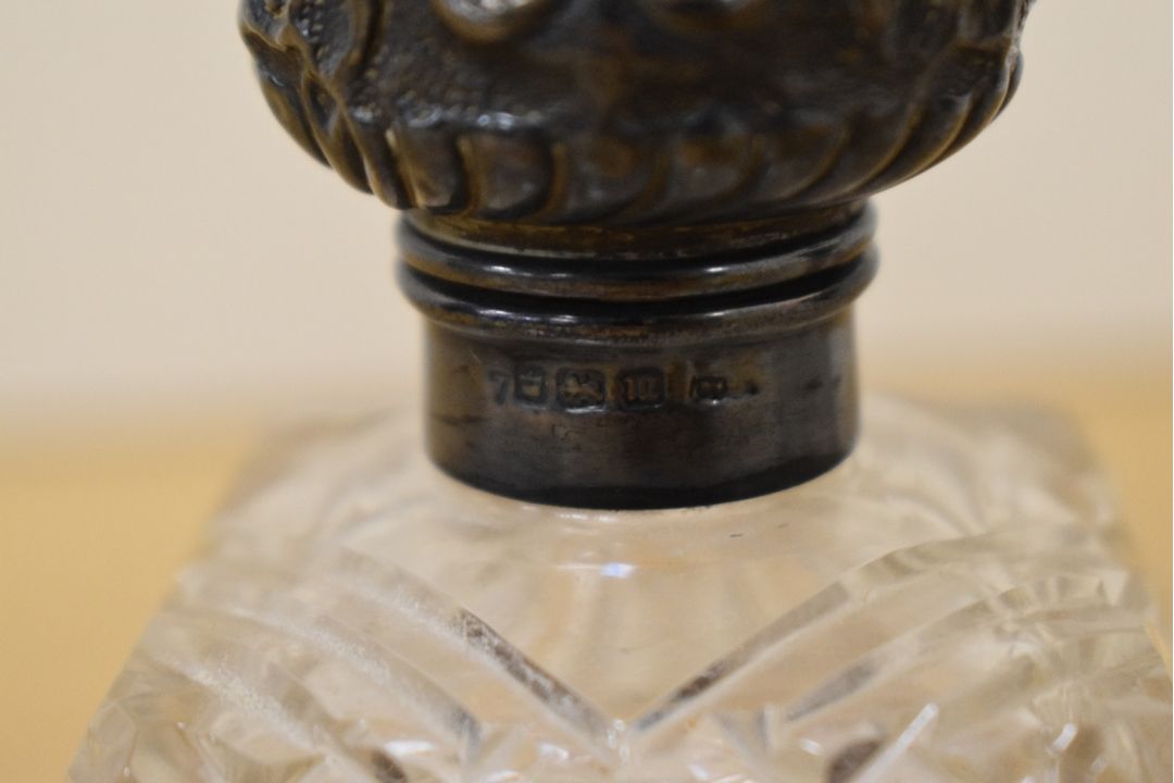 A pair of Edwardian cut glass scent bottles, having Walker & Hall silver lids hallmarked for - Image 2 of 2