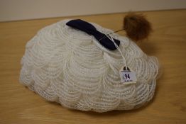 A vintage hat and a hat pin.