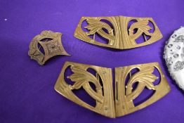 A vintage beaded evening bag and two Antique brass belt buckles.