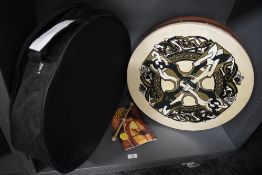 A Bodhran Irish drum with case and tuition book.
