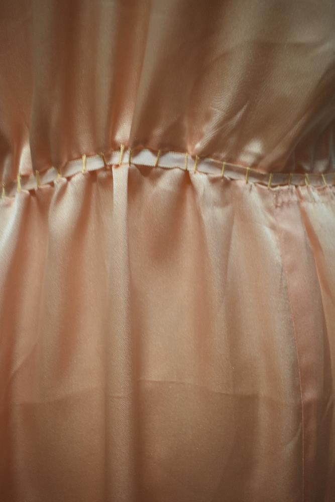A 1920s pale pink silky 1920s nightdress, having adjustable ribbon fastening to waist, pretty lace - Image 12 of 14
