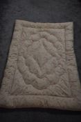 A 1930s ivory coloured paisley eiderdown.