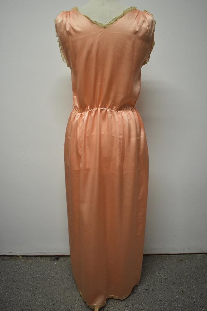 A 1920s pale pink silky 1920s nightdress, having adjustable ribbon fastening to waist, pretty lace - Image 9 of 14