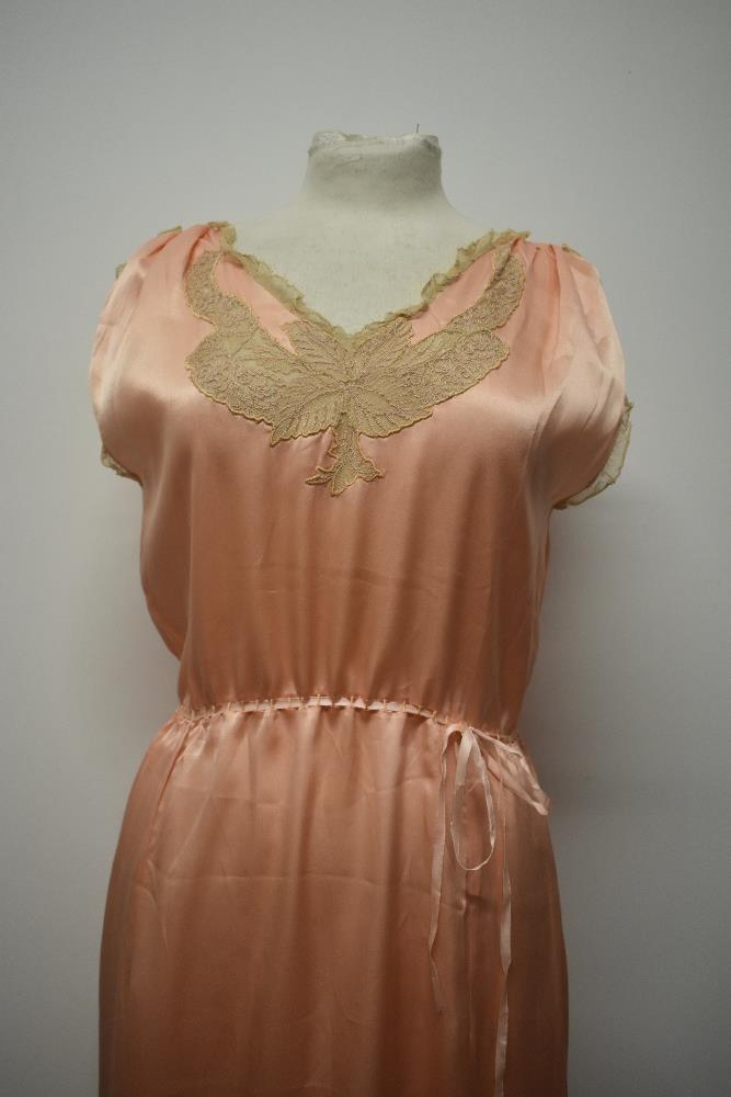 A 1920s pale pink silky 1920s nightdress, having adjustable ribbon fastening to waist, pretty lace - Image 2 of 14