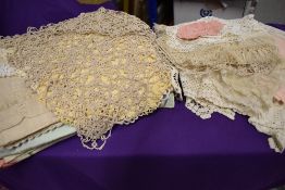 A collection of vintage and antique table linen, doyleys, cushion covers, pyjama case, edgings and