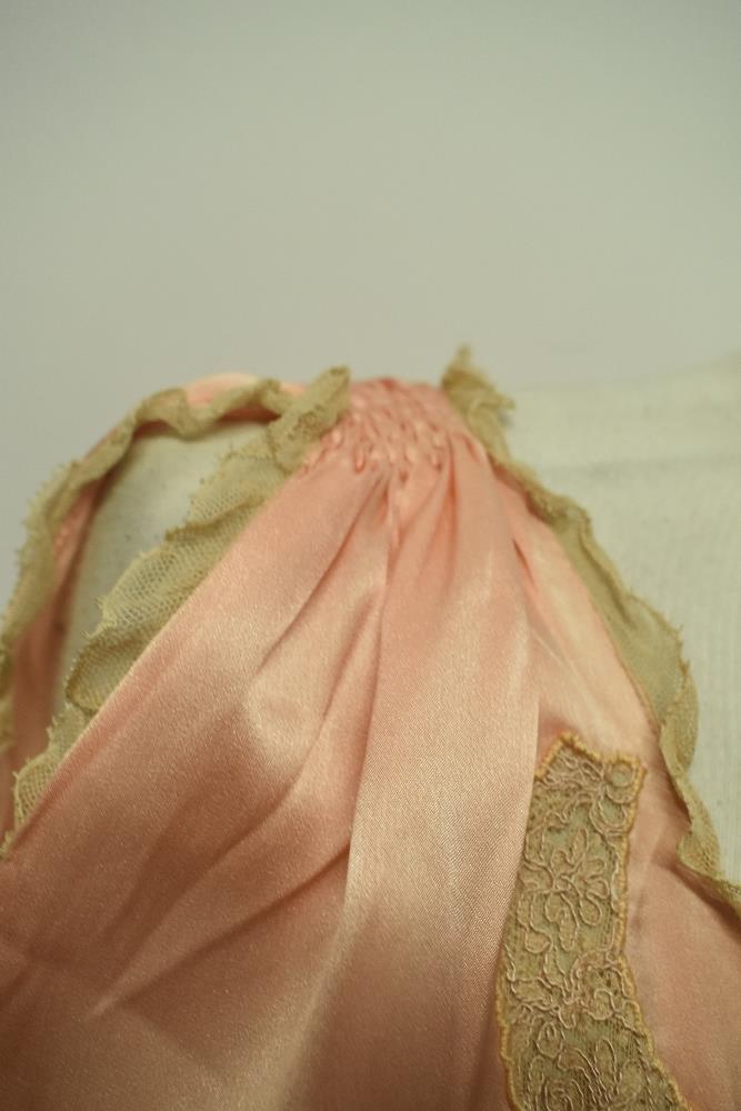 A 1920s pale pink silky 1920s nightdress, having adjustable ribbon fastening to waist, pretty lace - Image 8 of 14