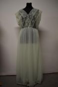A vintage mint green nylon nightdress, having double layered skirt and floaty lace to bodice,