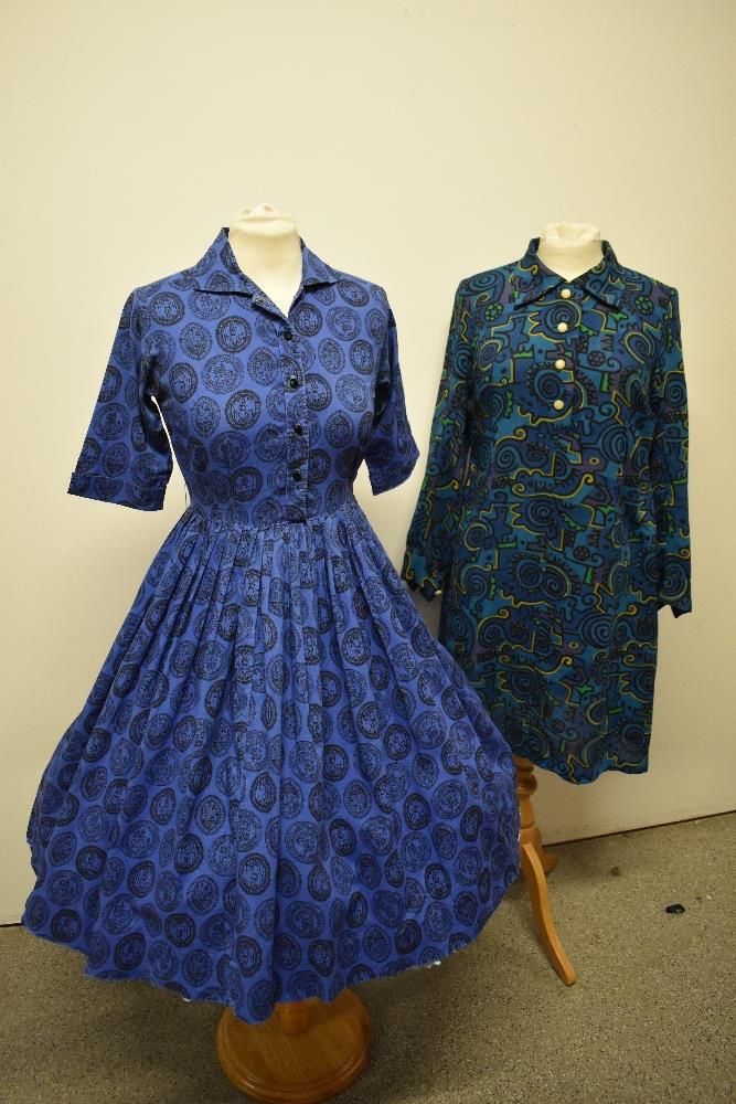 A 1950s full skirted cotton day dress, having brilliant novelty medallion print on cobalt blue