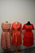 Three vintage dresses, including red dress, with tiered skirt and rear metal zip and striped linen