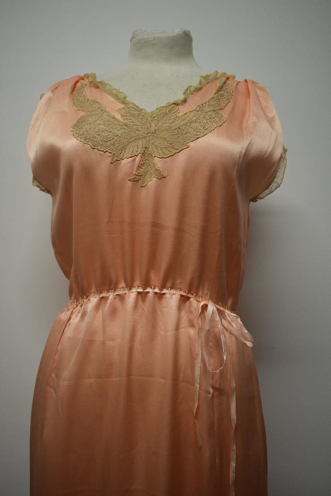 A 1920s pale pink silky 1920s nightdress, having adjustable ribbon fastening to waist, pretty lace - Image 4 of 14