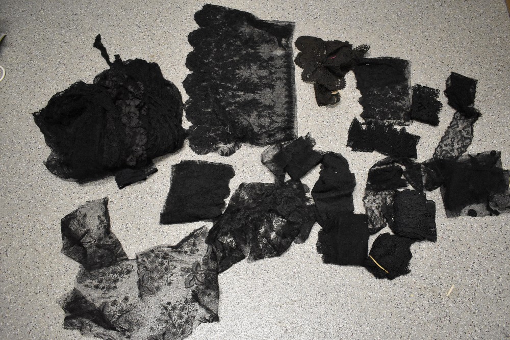 A collection of remnants of vintage and antique black lace and crochet, some have been removed off