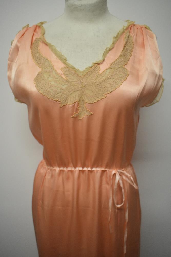 A 1920s pale pink silky 1920s nightdress, having adjustable ribbon fastening to waist, pretty lace - Image 3 of 14