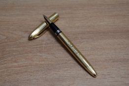 A Sheaffer TD Triumph snorkel fill fountain pen in gold fill with white spot cap having Sheaffer