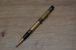 A Mabie Todd & Co Fyne Poynt propelling pencil set in black with gold overlay and several decorative