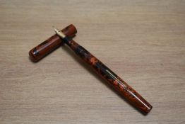 A Mabie Todd & Co Swan Self Filling lever fill fountain pen in black and red hard rubber with