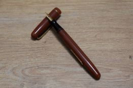 A Mabie Todd & Co Swan 3173 self filler lever fill fountain pen in coral with one narrow band to the