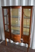 An Edwardian mahogany display cabinet with inlaid decoration, on square tapered legs with spade