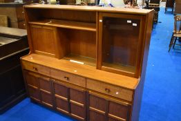 A vintage teak sideboard/dresser by Nathan, having cocktail and display section over triple frieze