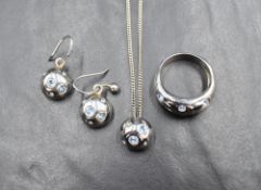 A French silver set of jewellery by Yves Saint Laurent comprising pendant, ring and earrings, all