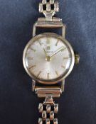 A lady's vintage 9ct gold wrist watch by Tissot having a baton numeral dial to champagne coloured