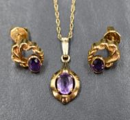 A 9ct gold and amethyst pendant with matched stud earrings having collared stones and twist gold