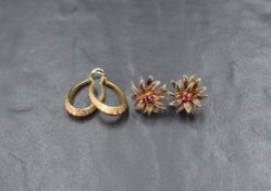 A pair of 9ct gold elongated hoop earrings having geometric decorative engraving, sold along with