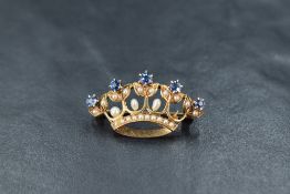 An Edwardian yellow metal coronet brooch powder blue sapphire and seed pearl decoration, (one