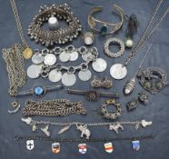 A selection of white metal and silver jewellery incluing bangle, brooches, rings, coin bracelet etc