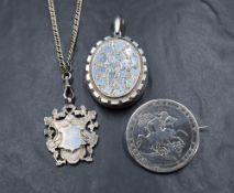 Three pieces of silver and white metal jewellery including a Georgian coin brooch dated 1820, a