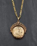 A 9ct gold spinning locket having floral motif engraving with a decorative rope-work frame, on a 9ct