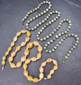 Two stone beaded necklaces, comprising a graduated yellow tone agate necklace of oval beads and a