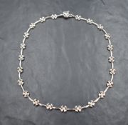 A 9ct white gold necklace having moulded flower and bar links, approx 16' & 19g