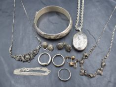 An assortment of silver and white metal jewellery, including a large hinged bangle with decorative