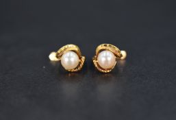 A pair of 18ct gold earrings set with cultured pearls in a decorative swirl motif, 1.8g