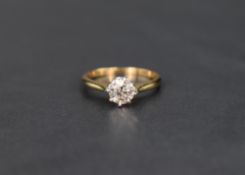 A diamond solitaire ring, approx 0.6ct in a raised claw set mount on a yellow metal loop, no
