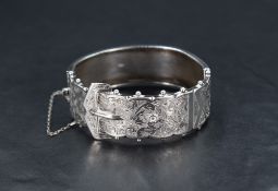 A Victorian silver hinged bangle in the form of a buckled belt, internal diameter 55mm x 48mm,