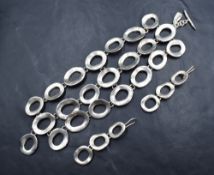 A silver triple row bracelet by John Rocha of Artisan style having bar and loop clasp, with matching