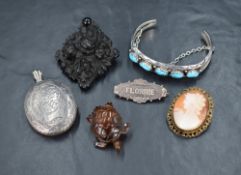 A small selection of vintage jewellery including black mourning brooch, silver locket having