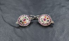 A pair of silver loop drop earrings, possibly Indian having a multi stone central panel within a