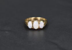 An opal trio ring having three opals in a gallery mount on a 9ct gold loop, size P & approx 2.5g