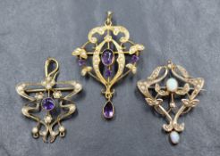 Three Edwardian yellow metal pendants, all stamped 9ct and having seed pearl decoration, two with