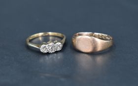 A diamond chip trilogy ring having an illusionary setting on a yellow metal loop stamped 9ct, and