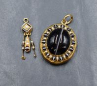 A Victorian gold hair locket having a banded agate cabochon to front within a surround of split