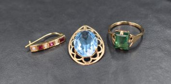 Three pieces of yellow metal jewellery, including pendant with oval blue paste stone, odd earring
