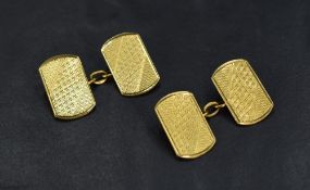 A pair of 18ct gold cufflinks of rectangular form with decorative engraving, 6.9g