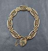 A 9ct gold gate bracelet having seven knot panels with brick effect connecting panels and a